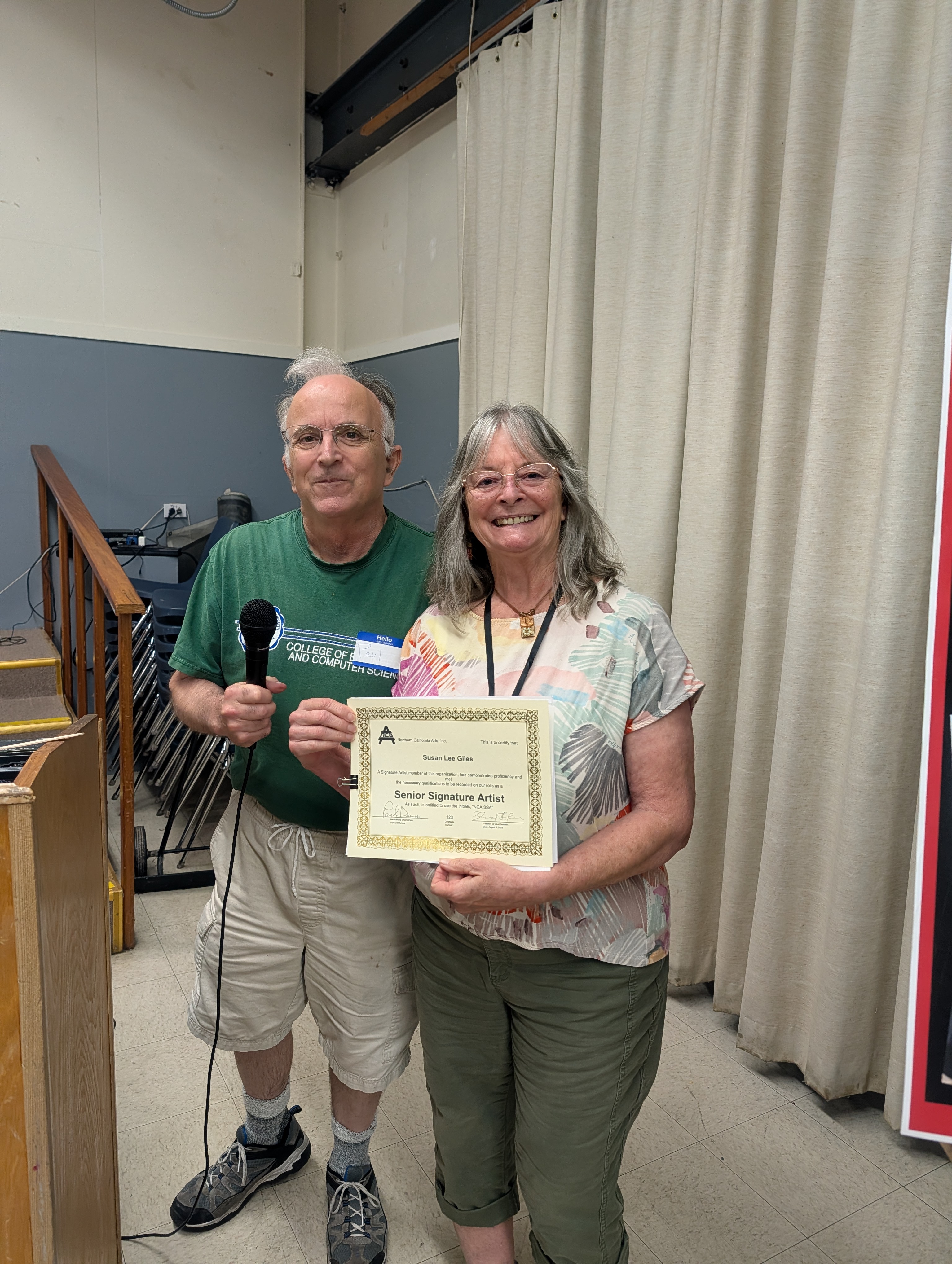 Paul Dessau awarding Susan Giles an artist standing certfifcate.